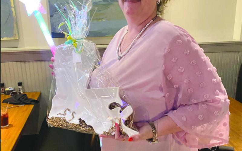 Tonya Soileau, of Pine Prairie High School, shows off a gift for being recognized as a support employee of the year state finalist. (Photo courtesy of Grace Sibley)