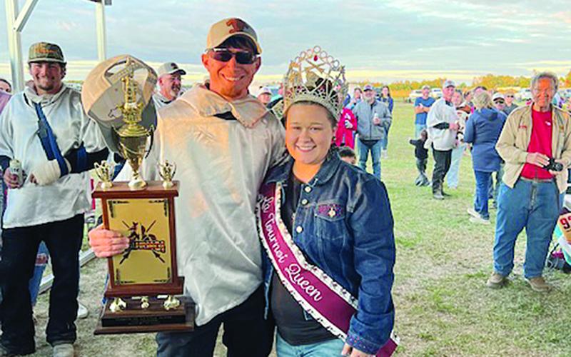 Tournoi champion Marcus Guillory (left) is presented his First  Place trophy by Tournoi Queen Shelbi Guidry. (Gazette photo by Tony Marks)