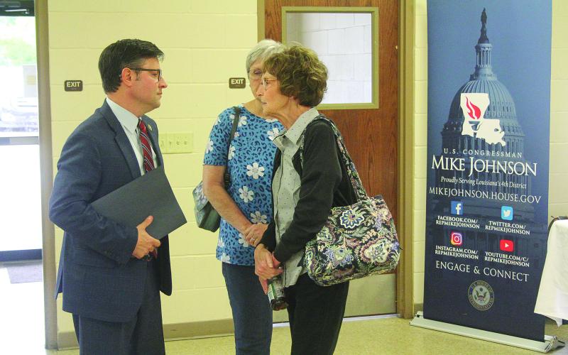 Congressman Mike Johnson visits with Linda Lebsack, member of the Evangeline Chamber of Commerce and library board.