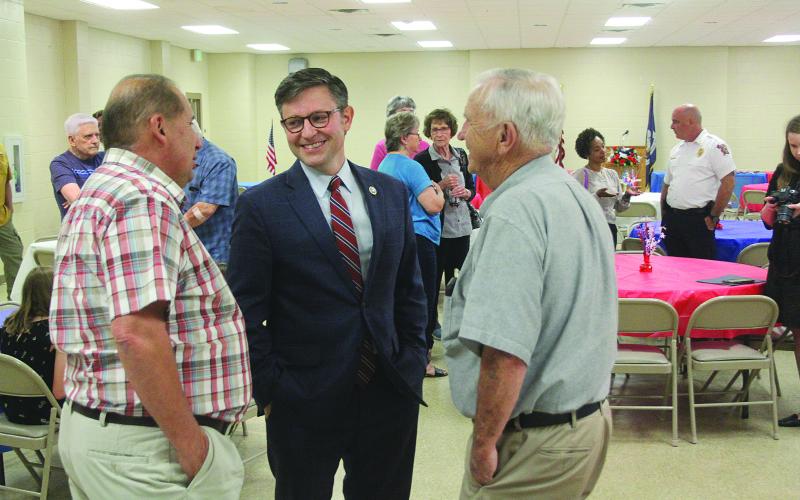 Congressman Mike Johnson (center), newly elected Speaker of the House of Representatives, shares a laugh with Joey West (left) and former School Board President Wayne Dardeau (right) during a town hall event held last year in Pine Prairie. (Gazette photo by Tony Marks)