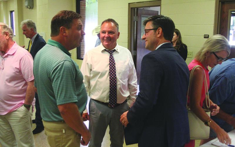 Toby Landreneau, with J. Ronald Landreneau and Associates, (left) shares a story with Mayor West (center) and Congressman Johnson (right).