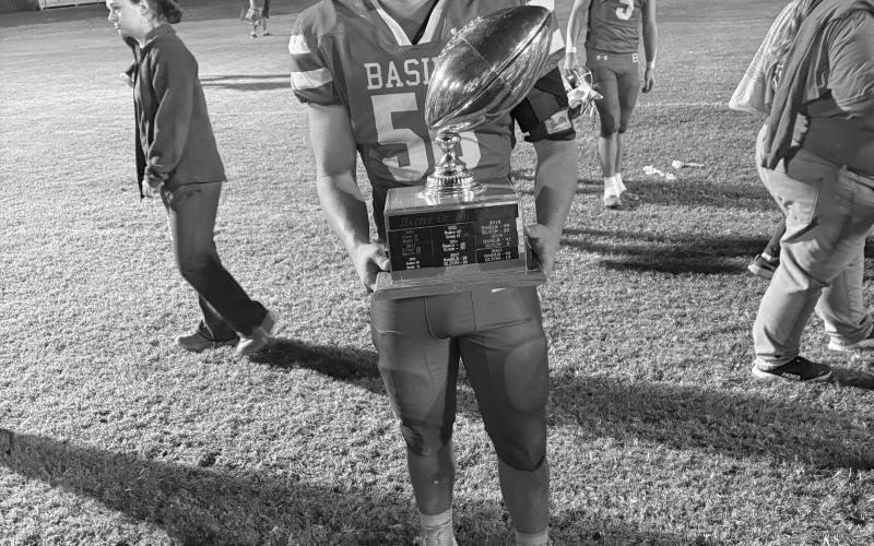 Gabe David, of the Basile Bearcats, is pictured with the Battle of Bayou Nezpique Trophy after beating Elton last Friday night. (Gazette photo by Tony Marks)