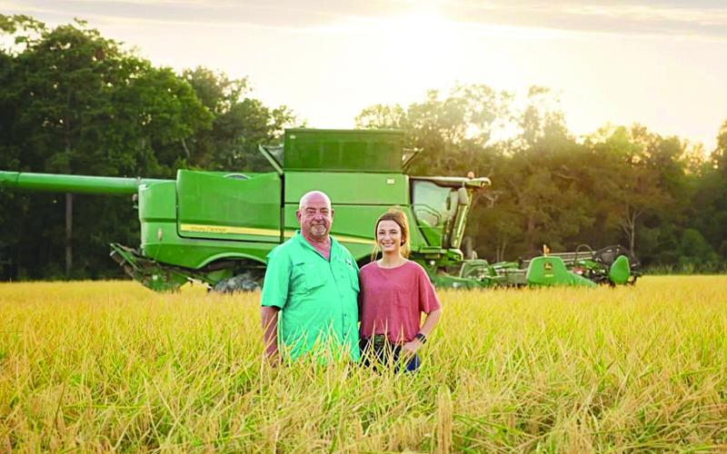 Troy Fruge with his daughter, Kynlee, on the Fruge Farm in Te-Mamou.