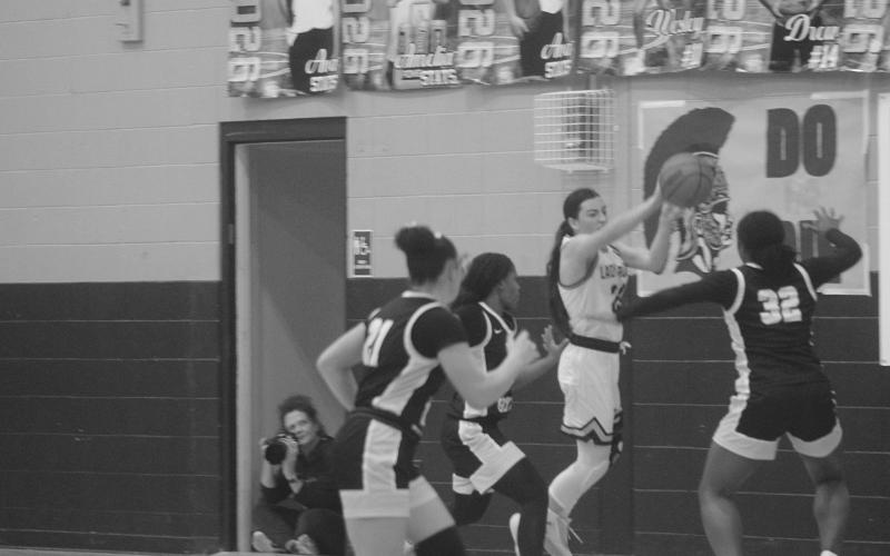 Bre Ardoin (24) keeps the basketball from going out of bounds for Sacred Heart in the finals of the girls’ Turkey Tournament against Jena. The Lady Trojans were the runner-up after a 64-37 loss to the Lady Giants. (Gazette photo by Tony Marks)