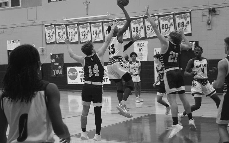 Ville Platte’s Sage Papillion (23) goes up for a basket while being defended by Sacred Heart’s Keegan McIntosh (14) and Austin Darbonne (21). (Gazette photo by Tony Marks)
