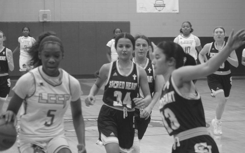 Olivia Tate (13) looks to make a defensive play in Sacred Heart’s 63-45 loss against Lake Charles College Prep. (Gazette photo by Tony Marks)