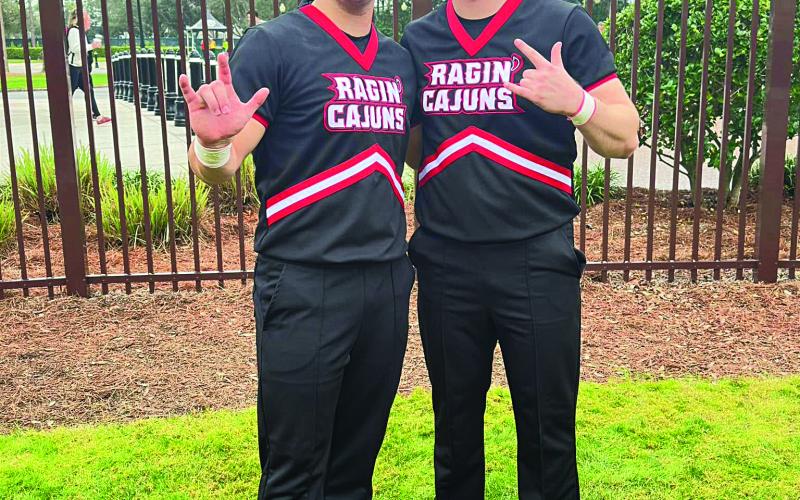 Christian Bergeron (left) and Isaac Cortez, both Basile High alumni, recently competed as members of the UL-L Ragin’ Cajun cheer leading team at the UCA National Collegiate Cheer leading competition in Orlando, where the Cajun squad placed second in the game day spirit contest.