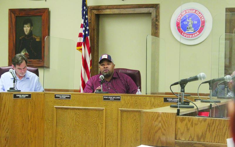 Ryan Leday Williams (right) conducts his first regular meeting after being elected  mayor of Ville Platte on Tuesday, January 10. Pictured on the left is new city clerk, treasurer, and tax collector Donald Bergeron. (Gazette photo by Tony Marks)