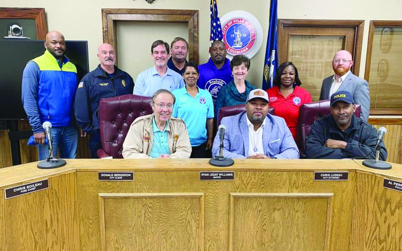 Pictured are (from left) back row- City Councilmen Tracey Jagneaux and Shawn Roy; middle row- Councilman Bryant Riggs, Fire Chief Chris Soileau, City Clerk Donald Bergeron, City Councilwomen Anna Frank, Faye Lemoine, and Christina Sam, and City Attorney Chris Ludeau; front row- KVPI General Manager Mark Layne, Mayor Ryan LeDay Williams, and Police Chief Al Perry Thomas. (Gazette photo by Nancy Duplechain)