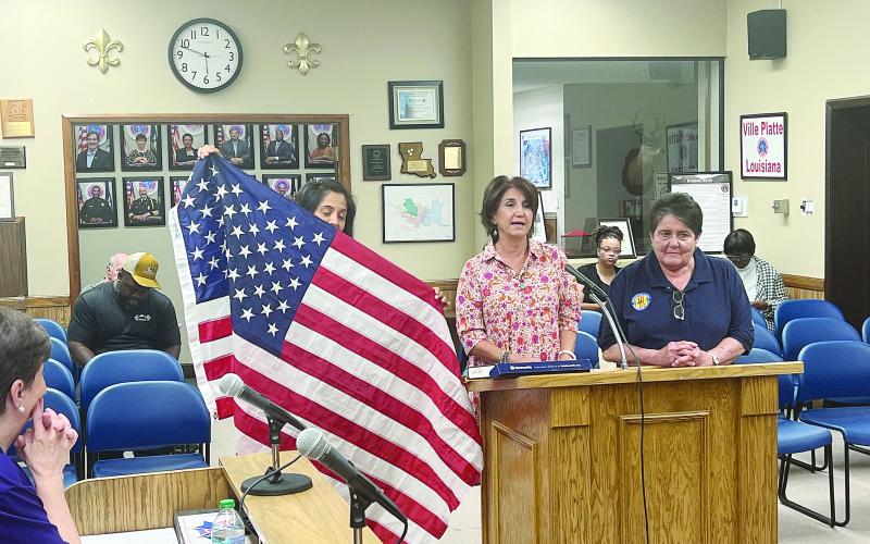 From left are Sarahi Sawtelle, Nina David, and Mable Foreman as they display a United States Flag at the Ville Platte City Council meeting held Tuesday, September 10. (Gazette photo by Tony Marks)