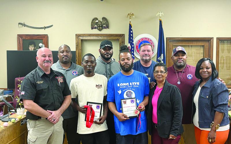 Pictured from left are (back row) Councilman Shawn Roy, Councilman Bryant Riggs, Councilman Tracey Jagneaux, and Mayor Ryan LeDay Williams; (front row) Fire Chief Chris Soileau, Jujaun Ben, Van Drecus Wilson, Councilwoman Anna Frank, and Councilwoman Christina Sam. (Gazette photo by Tony Marks)