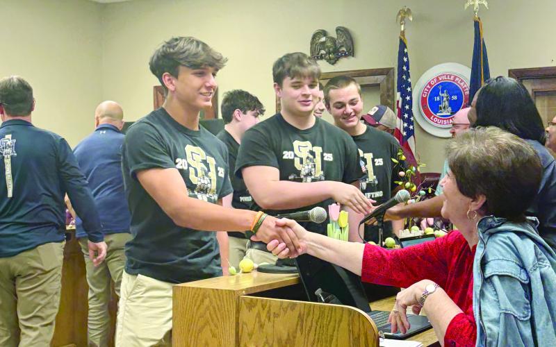 Gavin Patin, a powerlifting state champion, is pictured on the left as he meets Councilwoman Faye Lemoine (right). (Gazette photo by Tony Marks)