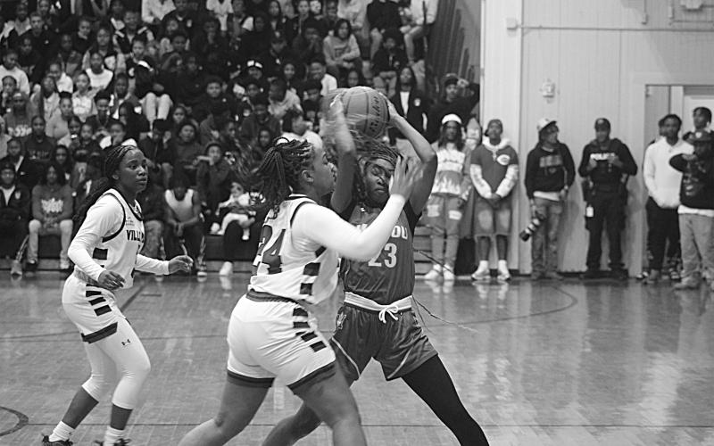 The Ville Platte Lady Bulldogs earned a 50-14 win over Port Barre in the first round of the playoffs at  home Thursday night. They will now play Mansfield at home in the second round. Pictured above is Raeosha Thomas (24) as she tries to get the ball away from Mamou’s Jalaysa Arvie (23) in a game earlier this season. (Gazette photo by Tony Marks)