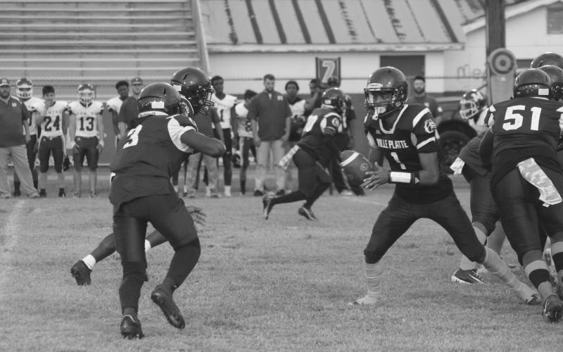 Ville Platte’s quarterback Jaquan Lavergne (1) looks to pitch the football back to Latelldrick Prejean (3) in the Bulldogs’ homecoming win over Mamou. (Gazette photo by Rhett Manuel)