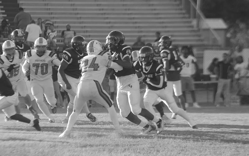 Darius Chagois (8) provides a block to allow Latelldrick Prejean (3) to pick up positive yardage for Ville Platte against Pine Prairie. (Gazette photo by Tony Marks)