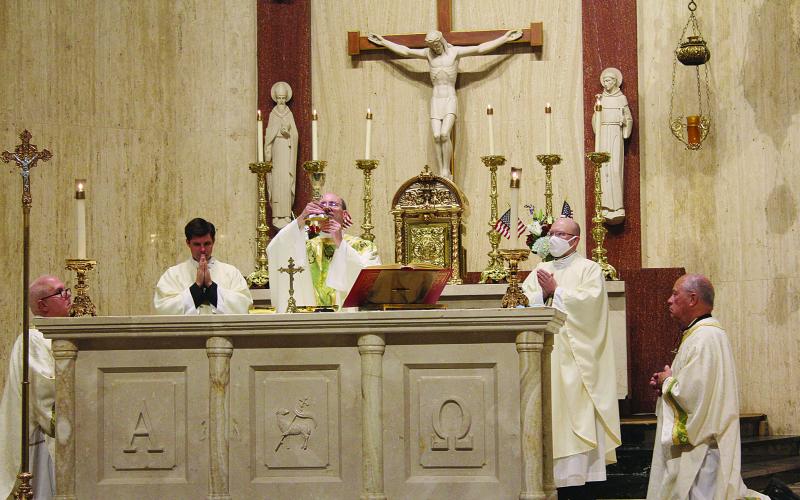 Fr. Voorhies, during the consecration of the Holy Eucharist, elevates the chalice belonging in Fr. LaFleur. The chalice was returned to Sacred Heart in 2016. Pictured on the left is Fr. Neil Pettit, pastor of St. Landry.