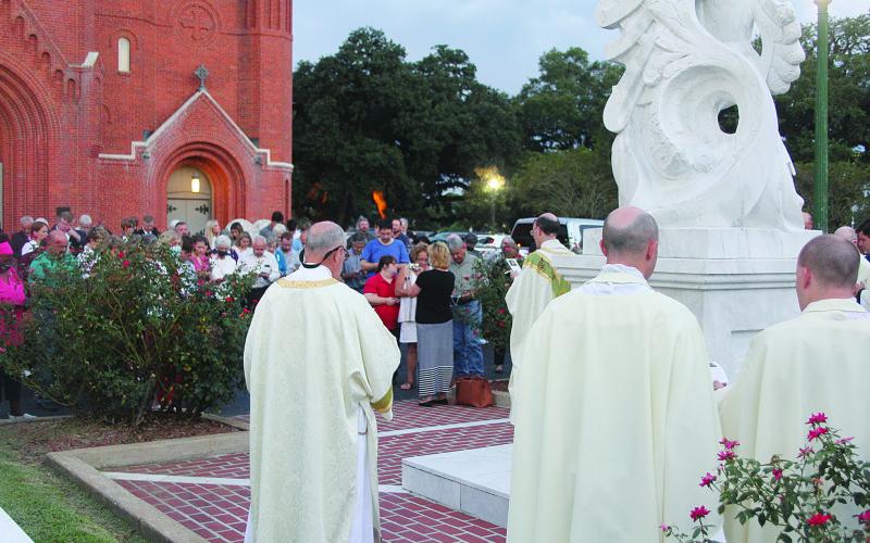 Outside at the memorial statue of Fr. LaFleur, Fr. Voorhies leads the public in a special prayer to the Servant of God. That title was given to Fr. LaFleur last year as his cause for canonization moved forward.