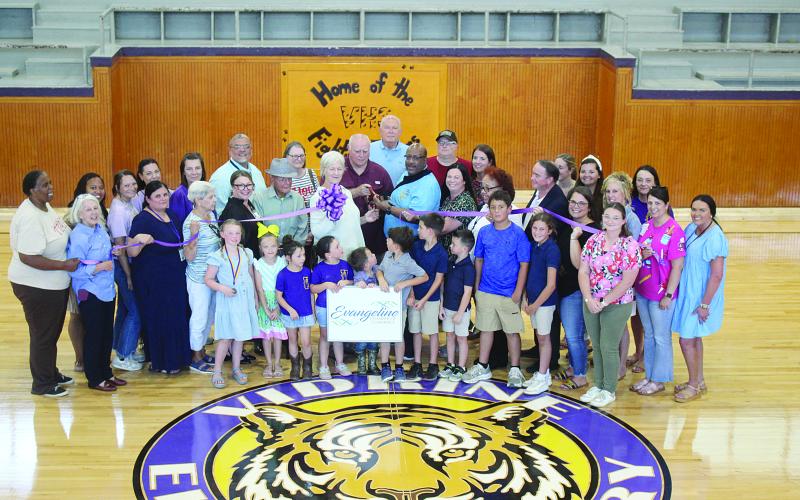 Among those pictured are Evangeline Chamber of Commerce board members Linda Fontenot and Dr. Gwen Fontenot, Elementary Supervisor Cherie Fontenot, Evangeline Parish School Board members Karen Vidrine and Bobby Hamlin, Superintendent Darwan Lazard, Assistant Superintendent Mike Lombas, Middle School Supervisor Sherral Tezeno, and Maintenance Supervisor Rico Guillory. (Gazette photo by Tony Marks)