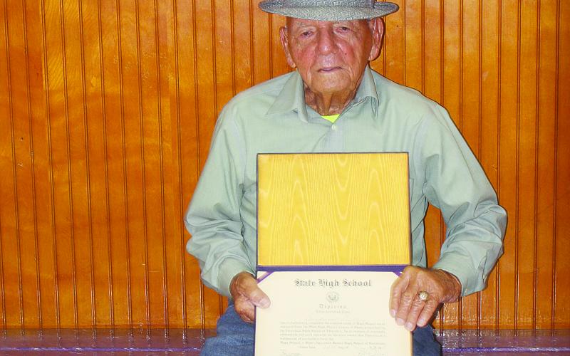 Also present for the ribbon cutting was Berdwoal Guillory, Vidrine High School Class of 1951. He was a member of the school’s boxing team and is pictured with his high school ring and diploma. (Gazette photo by Tony Marks)