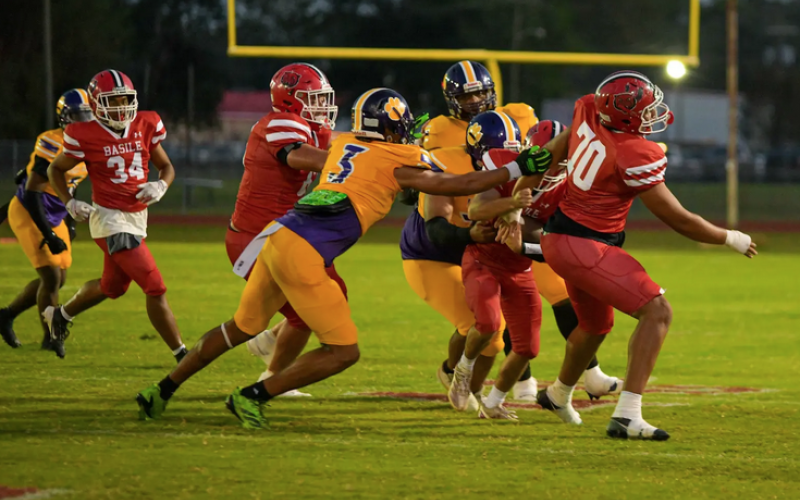 Cameron Seriale (3) and other members of the Ville Platte defense combine for a stop against the Basile Bearcats last Friday night as the Bulldogs earned their second win of the season. (Photo by Tonya Ortego)