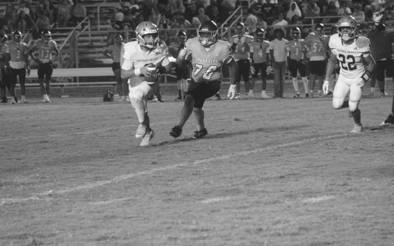 Ellis Fusilier (2) looks to find positive yards for his Sacred Heart Trojans in a loss to Westminster Christian Academy. (Gazette photo by Tony Marks)
