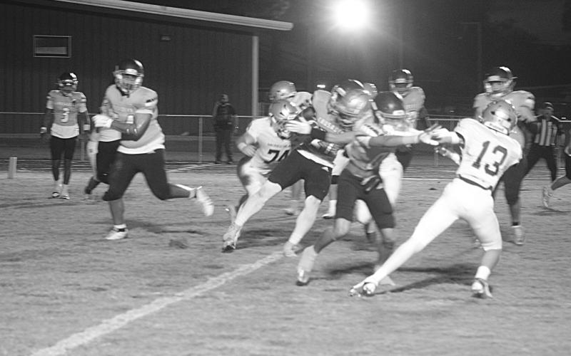 Members of the Sacred Heart defense Sully Manuel (13), Landon Fontenot (74), and Drew Mayeaux (28) combine for a stop against a Westminster player in the Trojans’ 14-7 road loss last Friday night. (Gazette photo by Tony Marks)