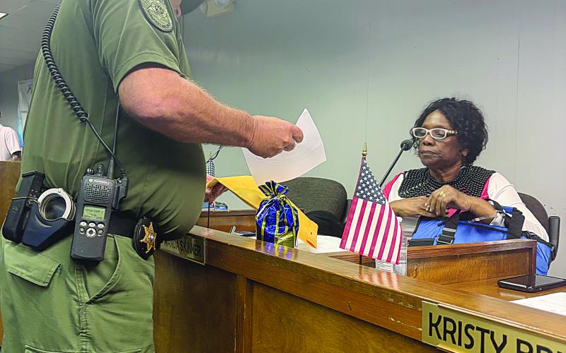 School Board member Wanda Skinner is pictured on the right as she is served with her court date, January 6, 2025, at 1 p.m. (Gazette photo by Tony Marks)