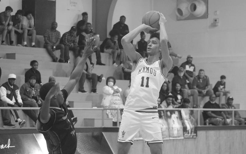 Braxton Ardoin (11) scores a goal for Mamou in its playoff-opening win against Winnfield. He led the Green Demons with 28 points in their 68-50 win. (Gazette photo by Tony Marks)