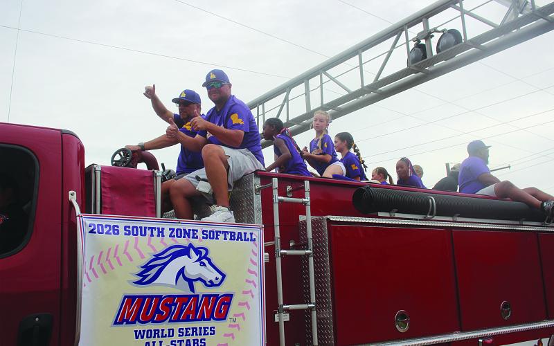 (Right photo) The Ville Platte 10U All-Stars also claimed the championship at the PONY World Series, which was played in Buda, Texas. Team members and coaches are pictured as they ride in a championship parade on Tuesday, July 14. Head coach is Delaney Fontenot; and players are Allie Rae Johnson, Aubrey Briley, Audrey Mire, Ella Veillon, Ellie Soileau, Kalie Herbert, Keeley Johnson, Madelyn Fontenot, Madison Ardoin, Maryellen Hebert, Olivia Delafosse, and Samiyah Thomas. (Gazette photo by Tony Marks)