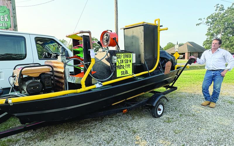 Chris Kalivoda shows off his new invention, the Gulf Zephyr, which is designed to lower water temperatures as a way of mitigating risks associated with hurricanes. (Gazette photo by Tony Marks)