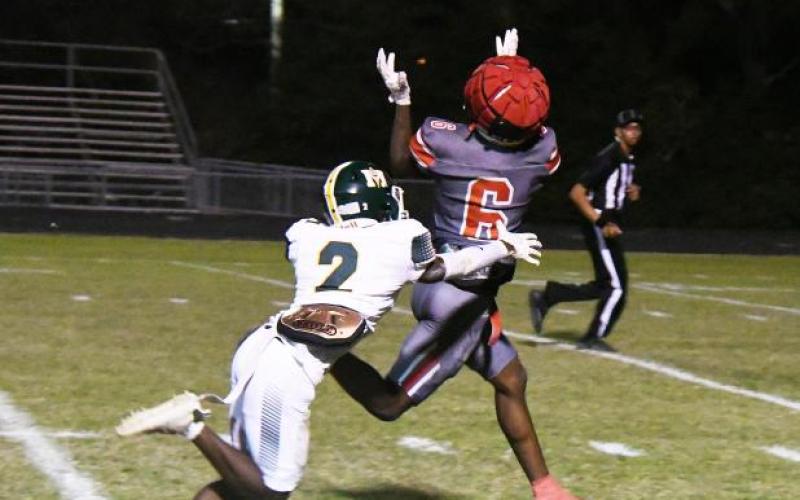 Kevin Jason (2) attempts to make a tackle on Abbeville’s Jacolby Campbell (6). (Photo courtesy of The Abbeville Meridional)
