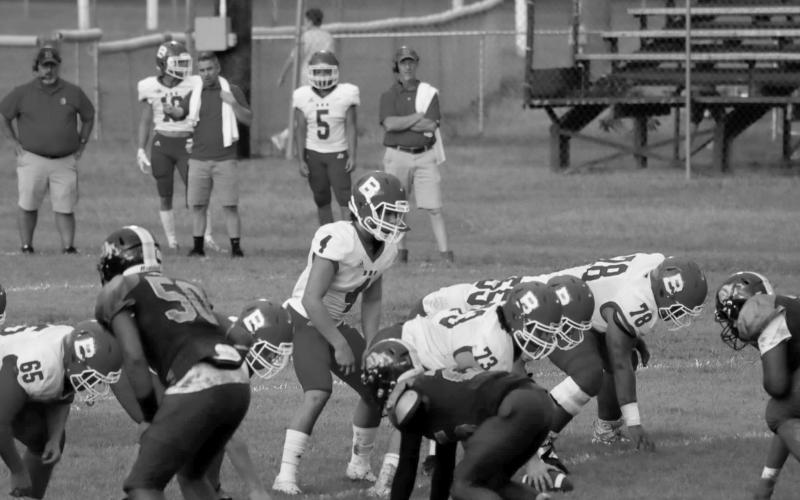 (At left) Bearcat quarterback Luc Johnson (4) lines up behind his center Christian Bergeron (73) in a game against Ville Platte earlier this season. Other identifiable Bearcats visible on the line are (from left) Emory LeJeune (65), Wyatt Bertrand (55), and Da’Shawn Randell (78). (Photo by Nikki Johnson)