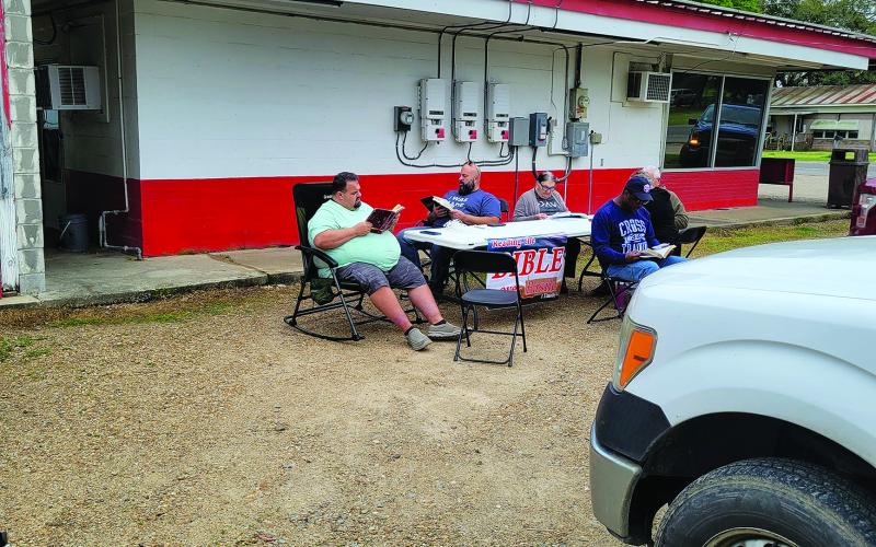 The parking lot of Chunkie’s Drive-In was one of the twelve posts where the Bible was read by 70 locals on March 9. Some of those taking part are shown above.