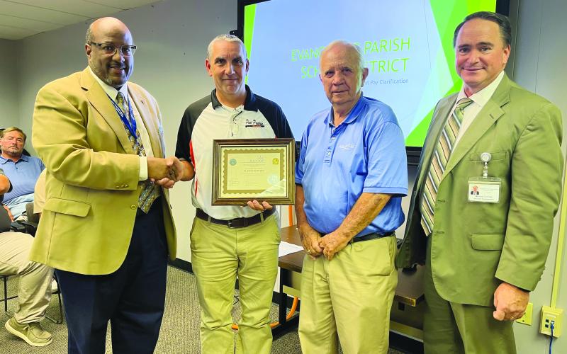 PPHS RECEIVES ASVAB AWARD - Pine Prairie High School received a platinum rating from ASVAB for the school’s 15 years of participation in and support of the ASVAB Career Exploration Program. Shown, from left, are Superintendent Darwan Lazard, Principal Toby Doucet, School Board President Wayne Dardeau and Assistant Superintendent Mike Lombas. (Gazette photo by Heather Bogard)