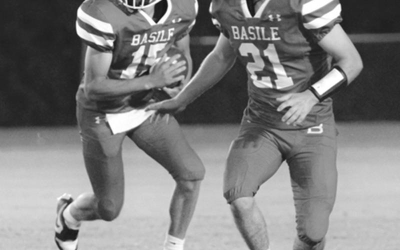 Bearcat quarterback Ricky Malone (15) follows the block of teammate Kye Smith (21) during Basile’s Homecoming game against the Ville Platte Bulldogs. (Photo by Tonya Ortego)