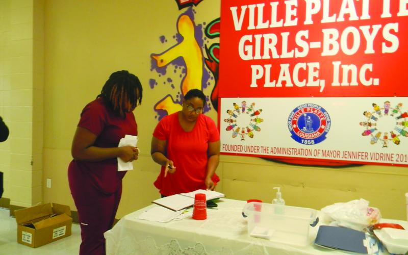 HEAD START SERVICES AVAILABLE - Sharron Gilbeaux, family service coordinator with Save the Children Head Start (right), assists a parent with registering her child for the 2022-20223 program year during the recruitment event held Wednesday, June 29, at the Girls and Boys Place in Ville Platte. (Gazette photo by Heather Bogard)