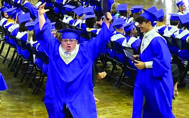 Brock Jordan jumps for joy after being declared a Sam Houston High grad. (Photo submitted)