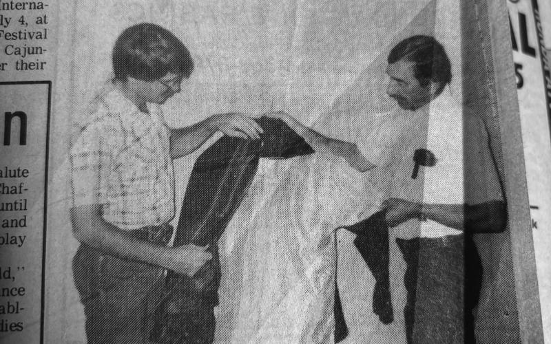 NEW TOURNOI UNIFORMS DISPLAYED - During the annual meeting of the Louisiana Tournoi Association in July 1987, 1986 Tournoi champion Kirt Guillory (left) and association president Gerald Fontenot (right) show off the new uniforms to be worn by the riders at the next Tournoi run later in the year. (Gazette archive photo)