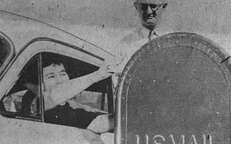DRIVE-IN POSTAL SERVICE INSTALLED - Mrs. Burkeman Veillon, a well known legal secretary in Ville Platte, tried out the new drive-in service as Postmaster P.F. Morein checked the mailbox for convenience and distance. Veillon joked, “You should fix it so we can pick up our mail  this way, too.” Morein commented in reply, “I’ll have to write Washington about it.” (Gazette file photo)