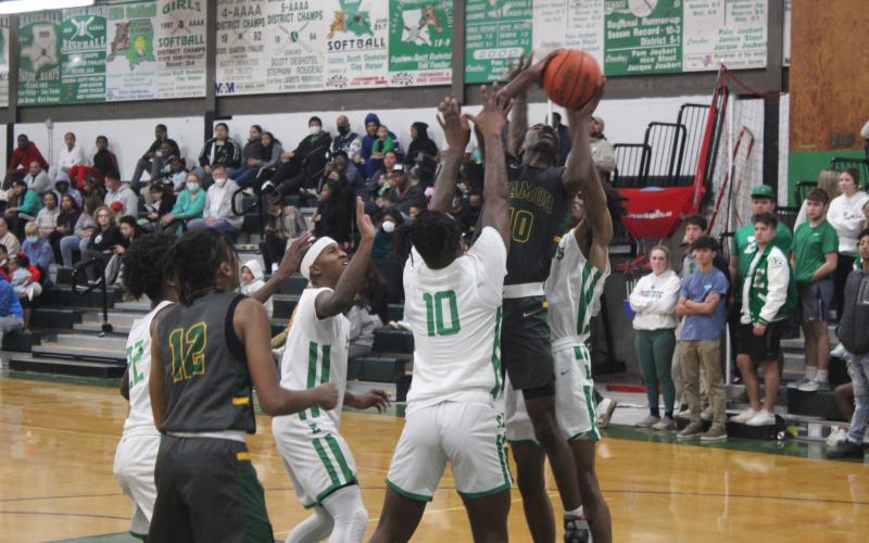 Mamou’s Tyrian Broussard (10) fights for a bucket in the Green Demons’ loss to Eunice, 72-59. (Gazette photo by Rhett Manuel)