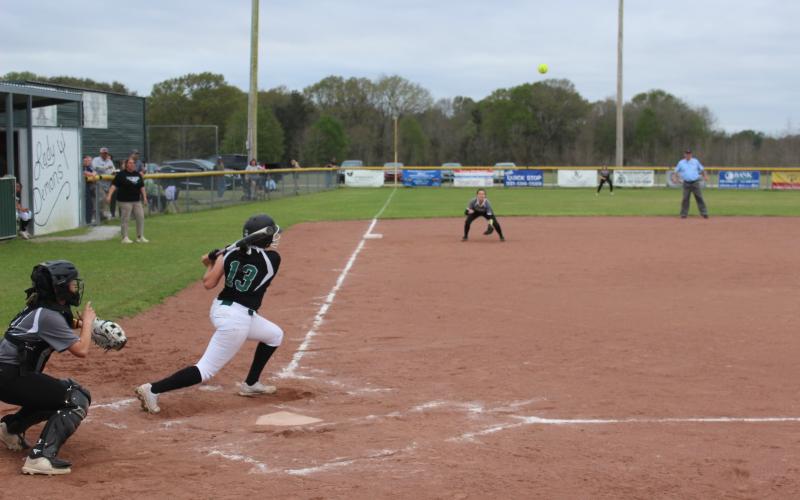 Maddie Fontenot (13) rips a base hit to left field in the Mamou Lady Demons’ 9-1 win over Church Point to improve to 11-5 on the season. (Gazette photo by Rhett Manuel)