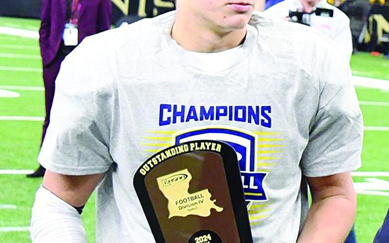 Jonathan Dartez holds his outstanding award trophy that he won after his Vermilion Catholic team won the LHSAA Football Division IV Select state championship. (Photo courtesy of Abbeville Meridional)