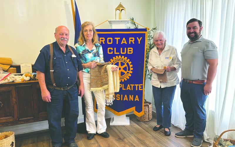 PASSION FOR COTTON SHARED - Belinda Berzas and Mavis Fruge shared their passion for cotton weaving and spinning to make various items. Shown from left, are Rotarian Bob Manuel, Belinda Berzas, Mavis Fruge and Rotary President Beau Wilson. (Gazette photo by Heather Bogard)