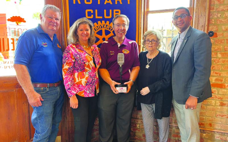 KVPI STAFF ADDRESSES GROUP -  Several staff members from KVPI spoke at the May 14, meeting of the Ville Platte Rotary Club to share the station’s history and unique format. Shown, from left, are KVPI staff members Mike Perron, Misty Parker (assistant manager), Mark Layne (general manager), Jackie Miller and Rotary President Brian Ardoin. (Gazette photo by Heather Bogard)