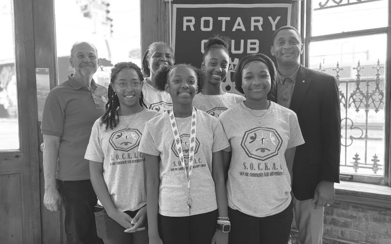 HEALTH COACH SHARES TIPS -  Shown, in front, from left, are Gustavia “Mozie” Sanchez, Nylah “Lex” Guillory and Ariena “Yoni” Boast. In the back row, same order, are guest speaker Neil Ortego, Rotarian Linda Fontenot, Zaleria “Z” Calvin and Rotary President Brian Ardoin. The students are participants in the Save Our Community Kids Adventure Camp. (Gazette photo by Heather Bogard)