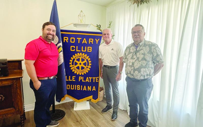 LELEUX SHARES JOY OF OFFICIATING - Keith LeLeux, center, addressed the July 7, meeting of the Ville Platte Rotary Club. He is shown with Rotary President Beau Wilson (left) and Rotarian Dan Poret (right). (Gazette photo by Heather Bogard)