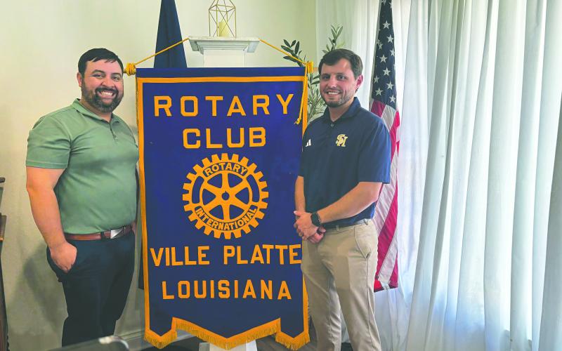 AGUILLARD DISCUSSES TROJAN FOOTBALL - Sacred Heart Athletic Director and head football coach Jacob Aguillard (right), addressed the July 15, meeting of the Ville Platte Rotary Club to discuss the upcoming football season. He is shown with Rotary President Beau Wilson (left). (Gazette photo by Heather Bogard)