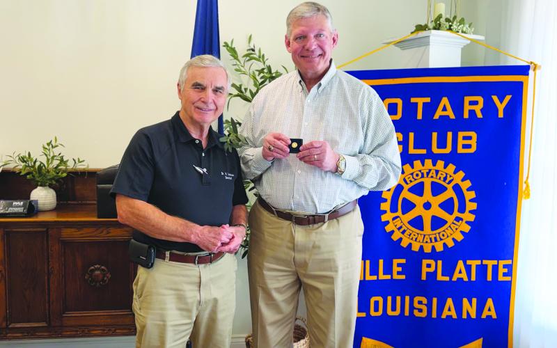PIN IS PRESENTED - During the July 21, meeting of the Ville Platte Rotary Club, Rotary President Dr. Kirk Soileau (left) presented Rotarian Peter Strawitz (right) with a seven-time Paul Harris Fellow Award pin. (Gazette photo by Heather Bogard)