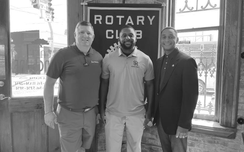 JONES DISCUSSES SHS BASKETBALL - New Sacred Heart High School basketball coach Cody Jones (center) visited the July 25, meeting of the Ville Platte Rotary Club as the guest of Dr. Jeb Cormier (left). They are shown with Rotary President Brian Ardoin (right). (Gazette photo by Heather Bogard)