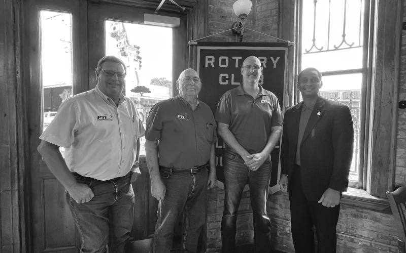 PTI TRAINING SCHOOL OPENED - Jarrod Schendel and Aaron Lemoine with PTI discussed the new service technician training school recently opened by PTI. From left are Rotarian Mitch Fontenot, Lemoine, Schendel and Rotary President Brian Ardoin. (Gazette photo by Heather Bogard)
